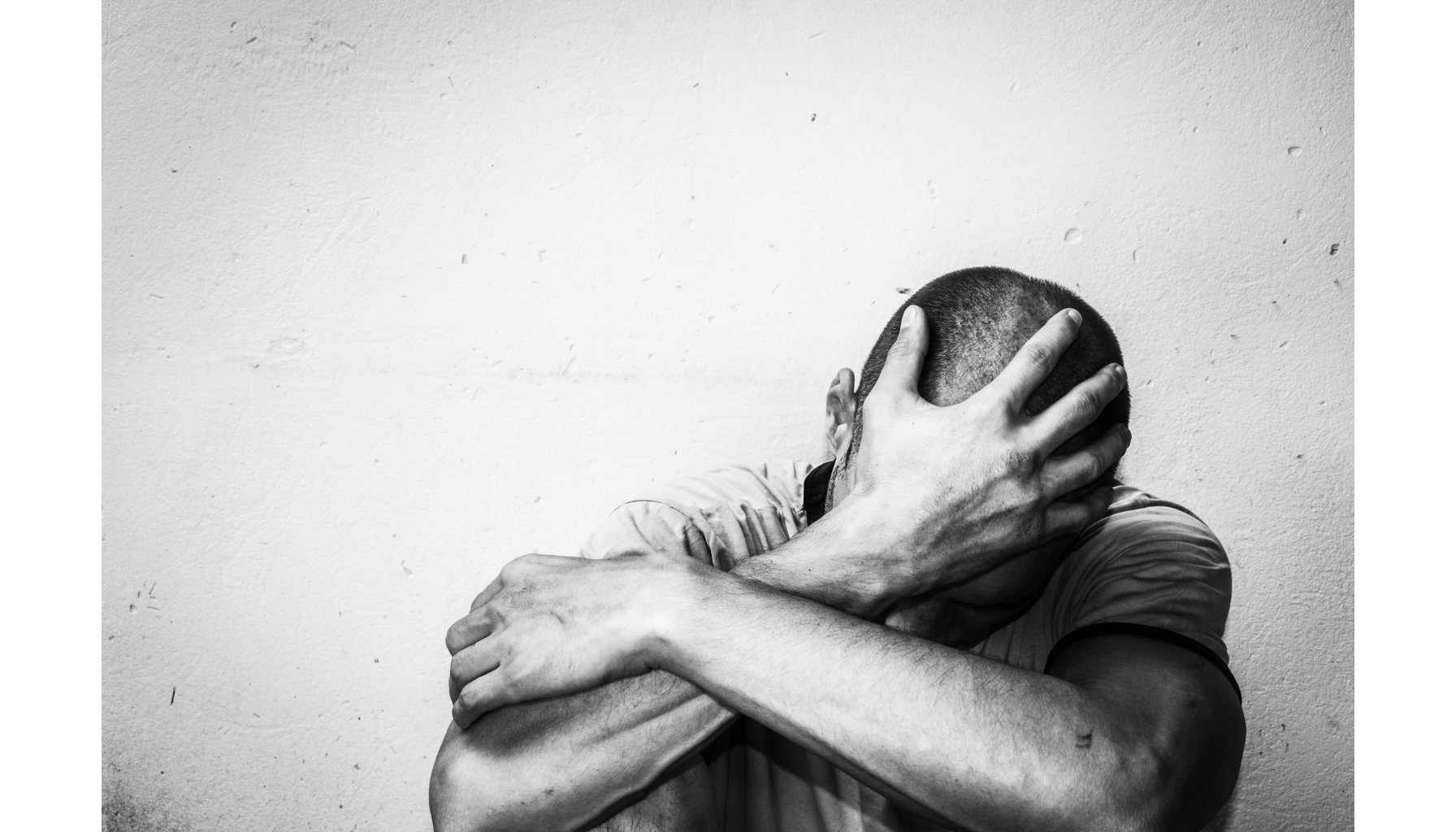 definition of addiction a man holding his head with his hands