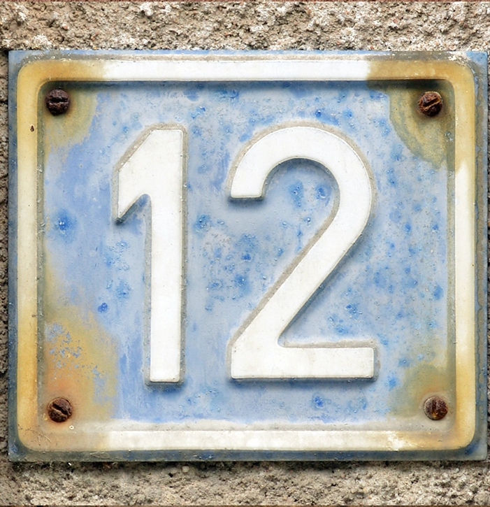 Weathered blue plate with a white number 12, representing Step 12 of the 12 Steps.