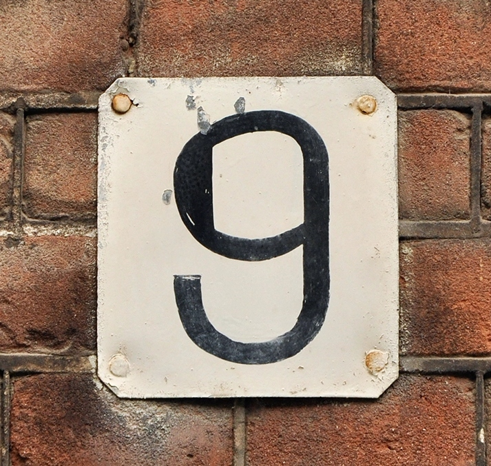 White enamel plate with a black number 9, representing Step 9 of the 12 Steps.